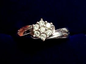 A white metal ring crossover set cluster of diamonds, size M to N, 5.2g