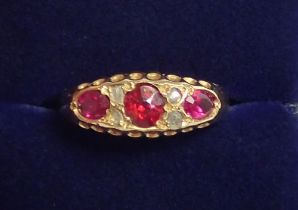 An 18 carat gold ring set three rubies and four old cut diamonds, size O, 2.5g