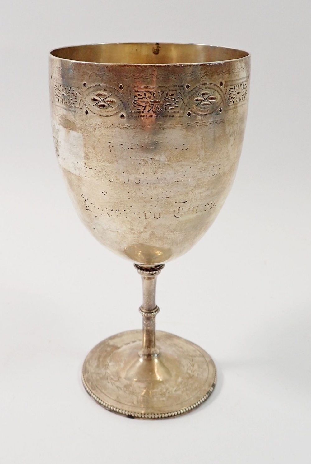 A Victorian silver goblet with engraved border, the inscription worn, 18.5cm tall by Charles