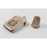 A silver vesta case with armorial and presentation inscription, Birmingham 909 and a silver thimble,