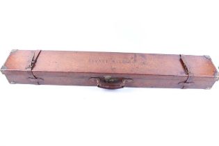 An oak and leather rifle case with brass corners, monogrammed Lionel Walrond, red baize lined fitted
