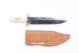 Bowie knife by E. Barnes, Sheffield, 9½ ins blade, brass guard, bone grips, in leather sheath