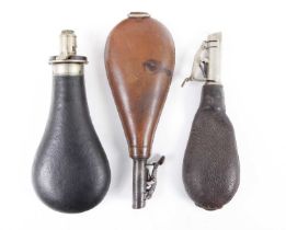 A leather covered powder flask by G & J. W. Hawksley, together with two leather shot flasks by