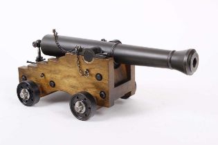 Ⓕ (S1) A scratch-built .69 black powder cannon, with a 14 ins smooth-bored barrel, on an oak