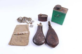 A brass and copper powder flask, shot flask, two vintage oil cans, and cleaning kit in pouch