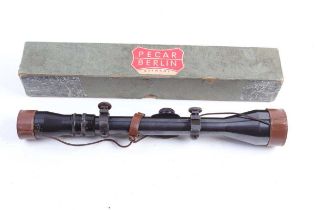 A 4-10 Variable Pecar Berlin rifle scope, boxed with mounts and leather covers