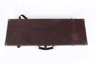 An oak and leather double gun case, red baize lined interior fitted for 28 ins barrels, brass
