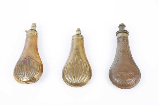 Three copper and brass powder flasks with various fluted , star and circles embossed decoration - Image 1 of 3