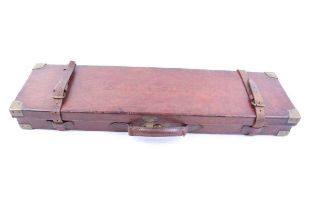 Leather gun case with brass corners, red baize lined interior fitted for 30 ins barrels, John Wilkes