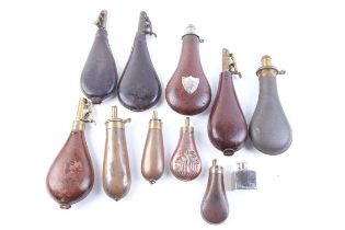 A collection of shot and powder flasks, maker's including G & J.W. Hawksley, James Dixon & Sons, and