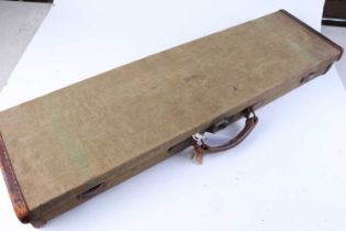 +VAT A canvas and leather gun case with fitted interior for 30 ins barrels, Wilkinsons trade label