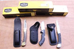 Three Buck folding knives, boxed (two with 3½ ins clip point blades)