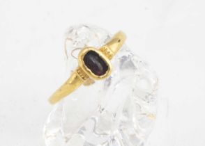 A medieval garnet and gold posy ring,