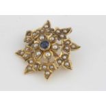 A yellow metal seed pearl and sapphire flower brooch,