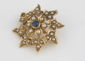 A yellow metal seed pearl and sapphire flower brooch,