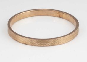 A late Victorian 9ct gold arm bangle,