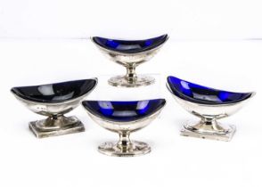 Two pairs of silver helmet shaped salts with blue glass liners,