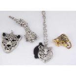 Four items of big cat costume jewellery,