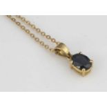 An 18ct gold sapphire pendant,