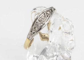An 18ct gold and platinum three stone diamond dress ring,