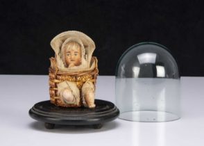 A German wax baby in a basket candy container,