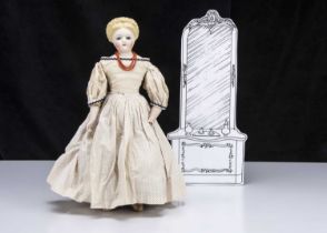 A rare German bisque shoulder-head doll with glass eyes and elaborate hair,