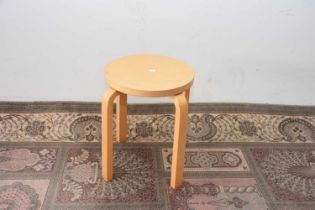 A modern Artek beech stool designed by Alvar Aalto