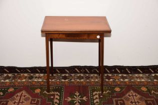 An Edwardian walnut and crossbanded card table,