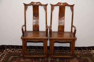 A pair of Chinese hardwood marriage armchairs