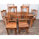 A modern mango wood and iron dining table and six chairs