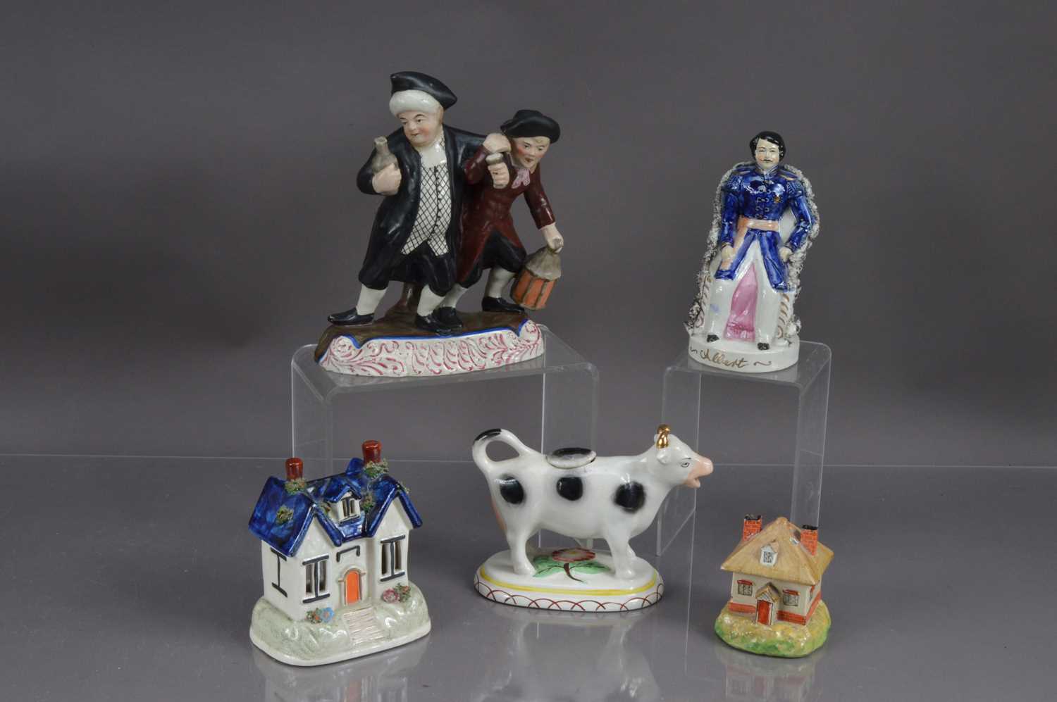 A group of five Staffordshire pottery figures, pastille burners etc,