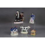 A group of five Staffordshire pottery figures, pastille burners etc,