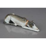 A late 19th / early 20th Century bisque porcelain whippet or greyhound