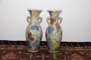 A pair of heavily restored c1920s Japanese earthenware vases,