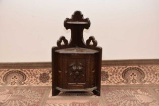 A second half 19th century Black Forest carved corner wall unit,