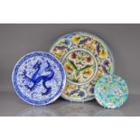 Three decorative pottery chargers and plates,