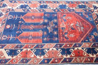 A vintage Middle Eastern woollen mihrab prayer carpet,