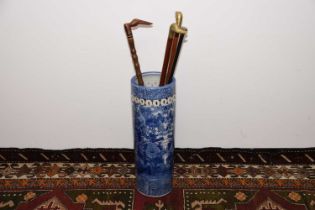 An early 20th century Japanese Arita style porcelain stick stand with four sticks and canes,