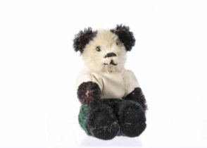 A post war miniature Schuco Panda dressed teddy bear,