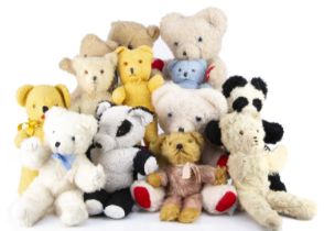Thirteen vintage unjointed teddy bears,