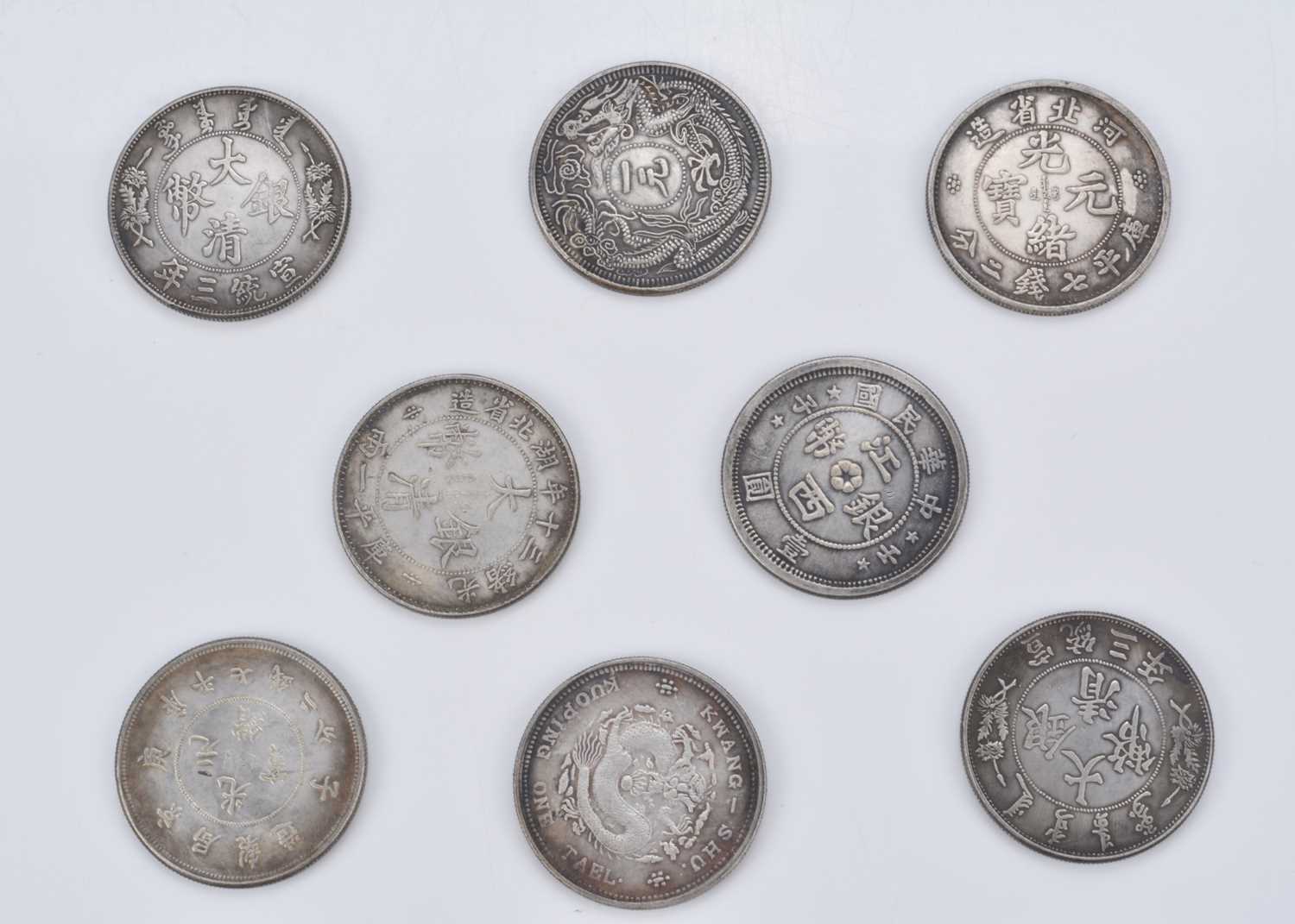 A collection of eight Far Eastern Chinese dollar style white metal medallions,