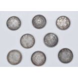 A collection of eight Far Eastern Chinese dollar style white metal medallions,