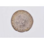 A white metal coin in the style of an Edward VI hammered silver shilling,