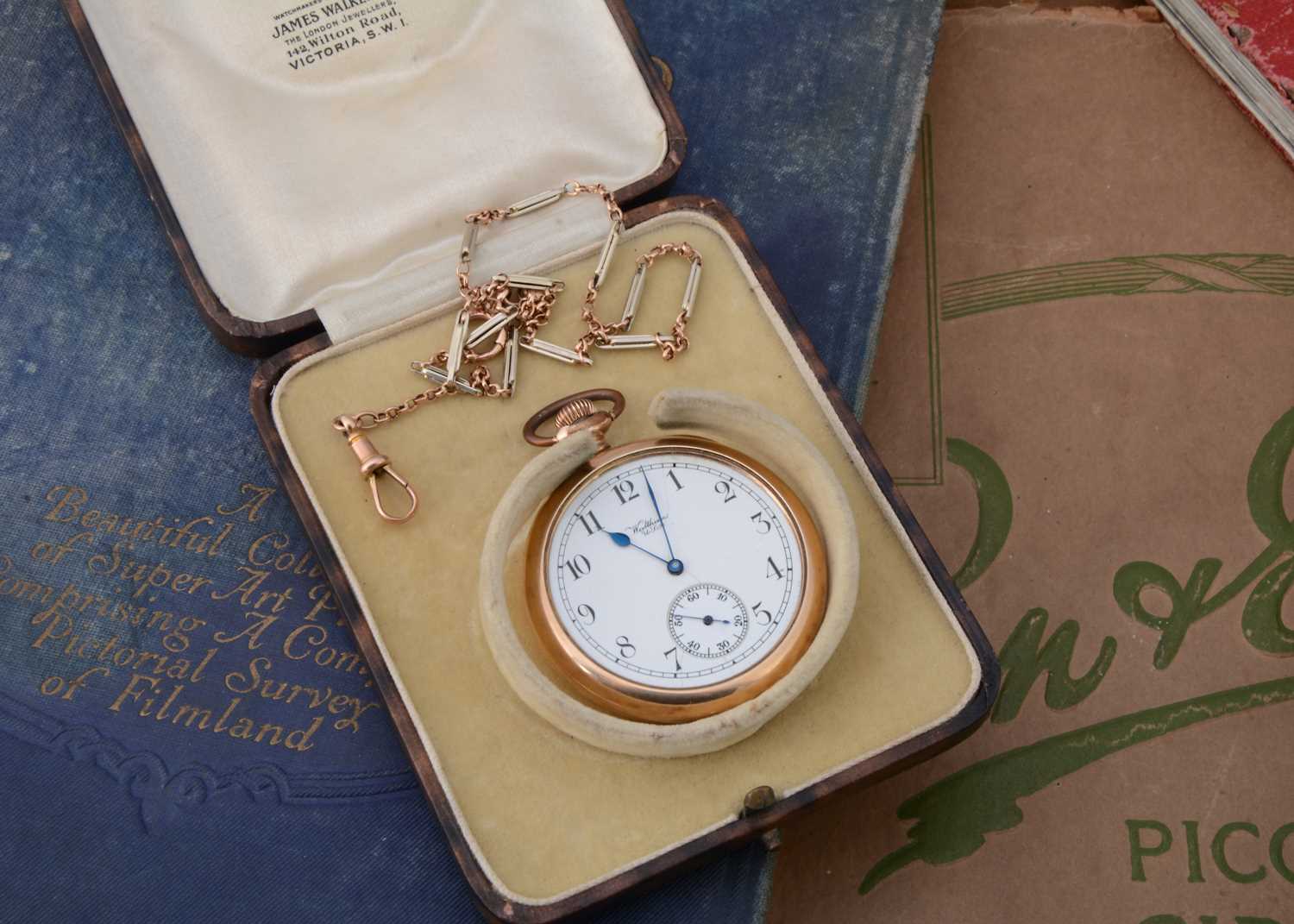 An early 20th century gold plated Waltham pocket watch with gold chain in box,