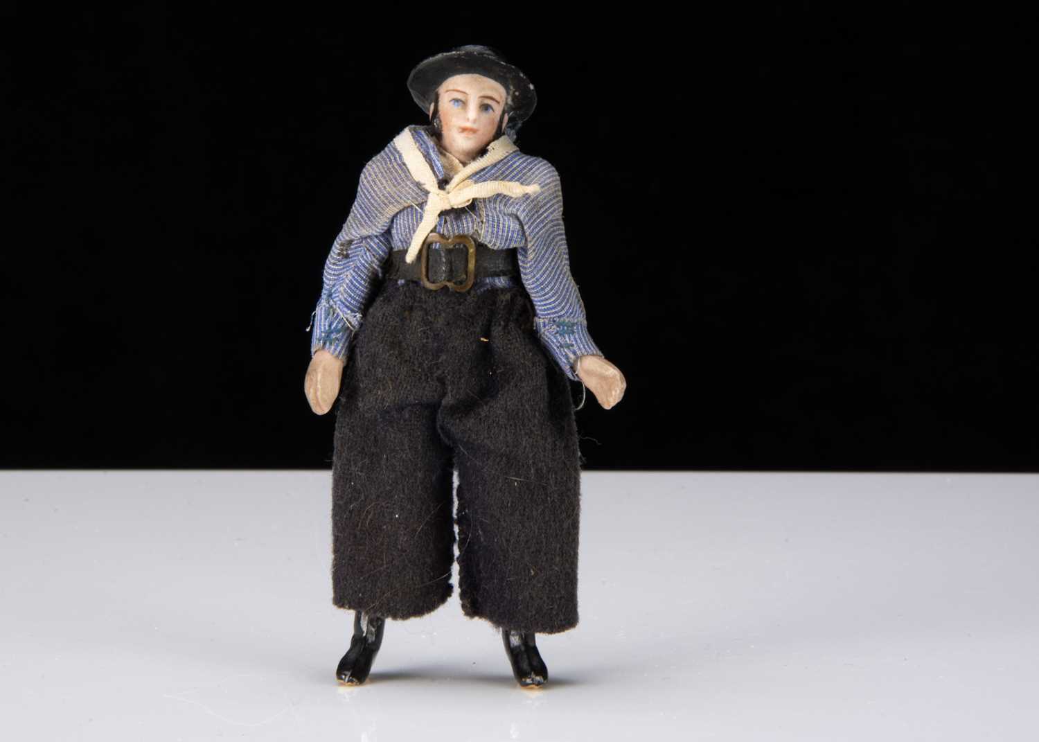 An unusual late 19th century all-bisque sailor doll,