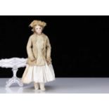 A 19th century French swivel head fashionable doll with jointed body,