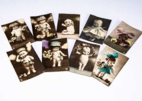 Nine real photograph postcard featuring googly eyed dolls with glass googly eye,