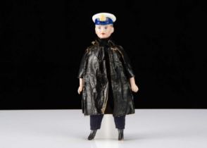 A German bisque shoulder head dolls’ house Royal Navy officer in oil-cloth coat,