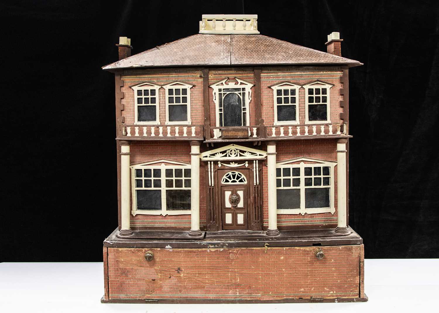 A 1930s part fretwork dolls’ house, possibly Hobbies Ltd with unusual pull-out garden,