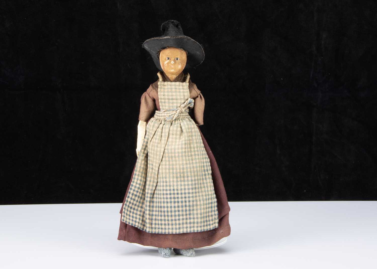 A 19th century English wax over papier-mâché doll in Welsh traditional costume,